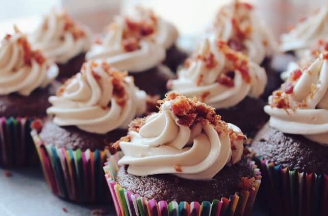 Chocolate cupcakes topped with swirls of vanilla buttercream