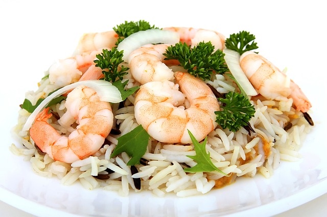 Shrimp served over seasoned rice with onion and fresh parsley