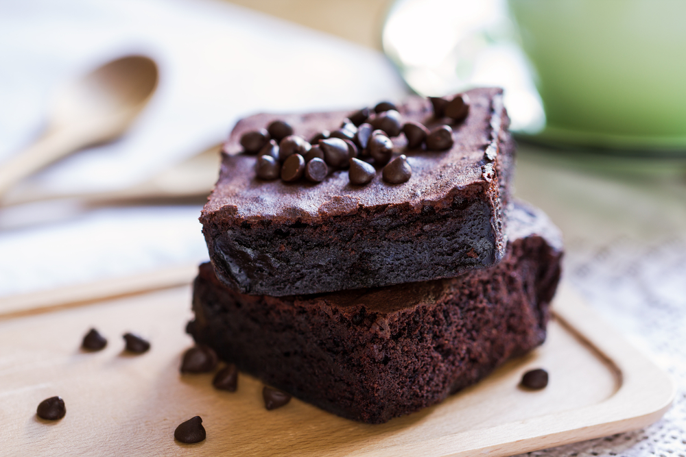 Two thick coffee brownies topped with chocolate chips