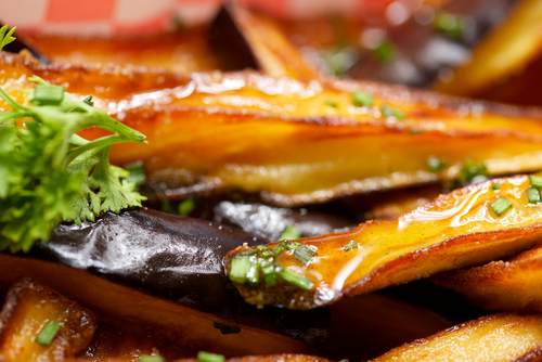 Glossy roasted aubergine wedges with herbs